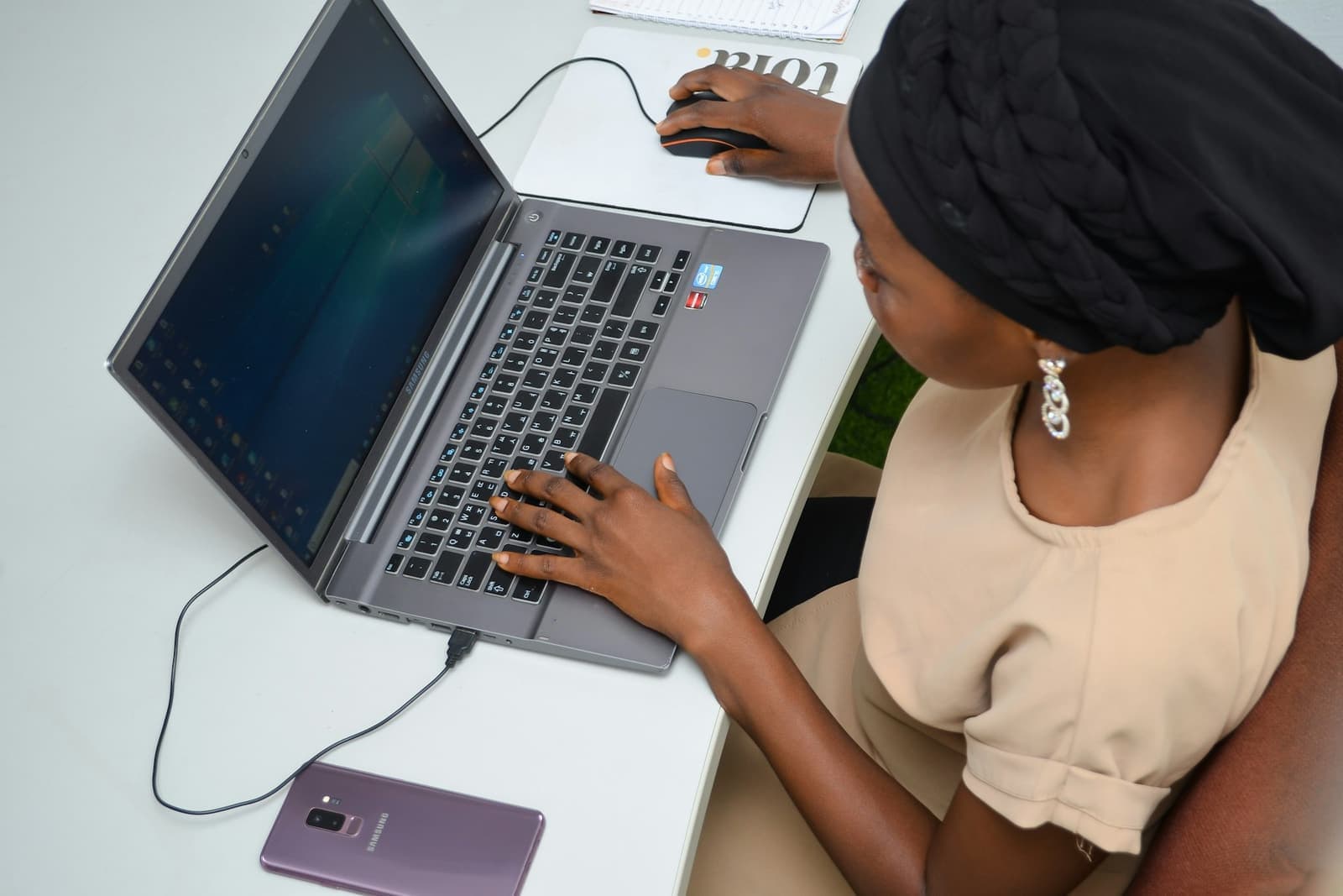 A freelancer working at a desk on a laptop